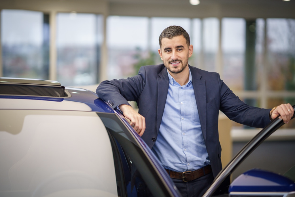 Jamal standing in the showroom of BYD